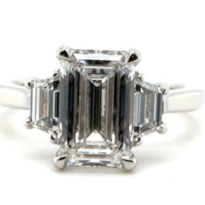Three Stone Emerald Cut Ring with Step-Cut Trapezoid Side Diamonds