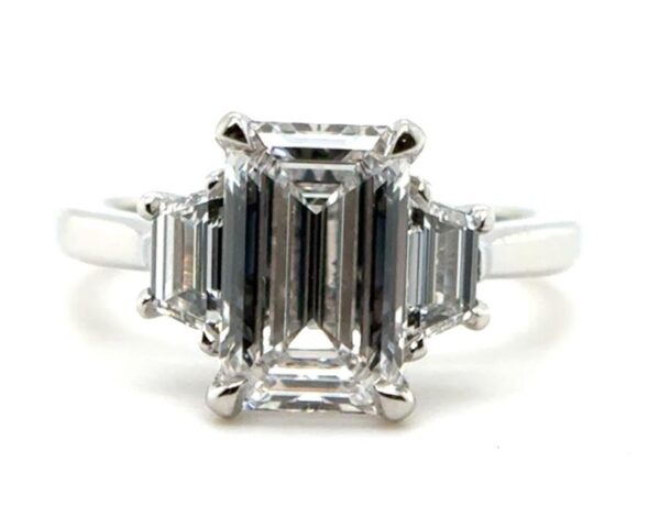 Three Stone Emerald Cut Ring with Step-Cut Trapezoid Side Diamonds