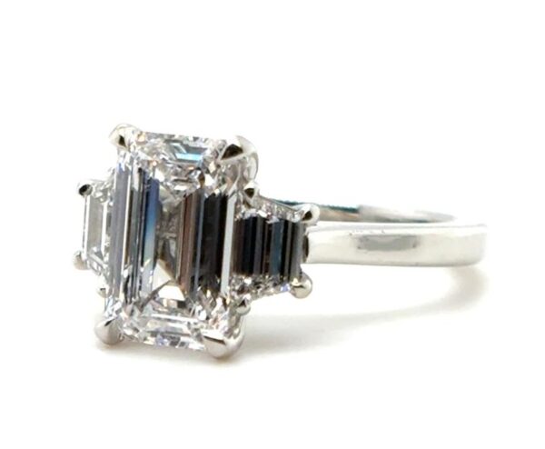 Three Stone Emerald Cut Ring with Step-Cut Trapezoid Side Diamonds - Image 4